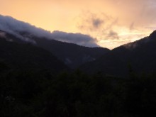 Sun sinking behind mountains