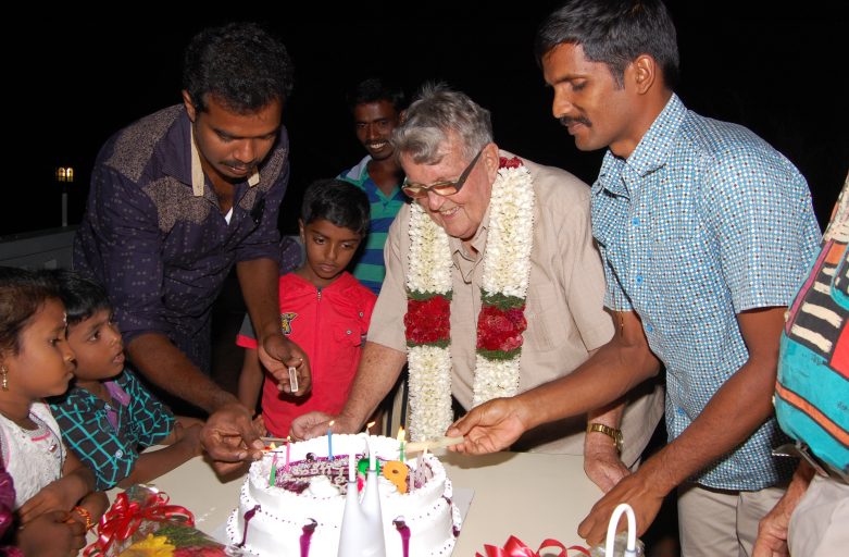 Chris Lucas cutting 80th birthday cake